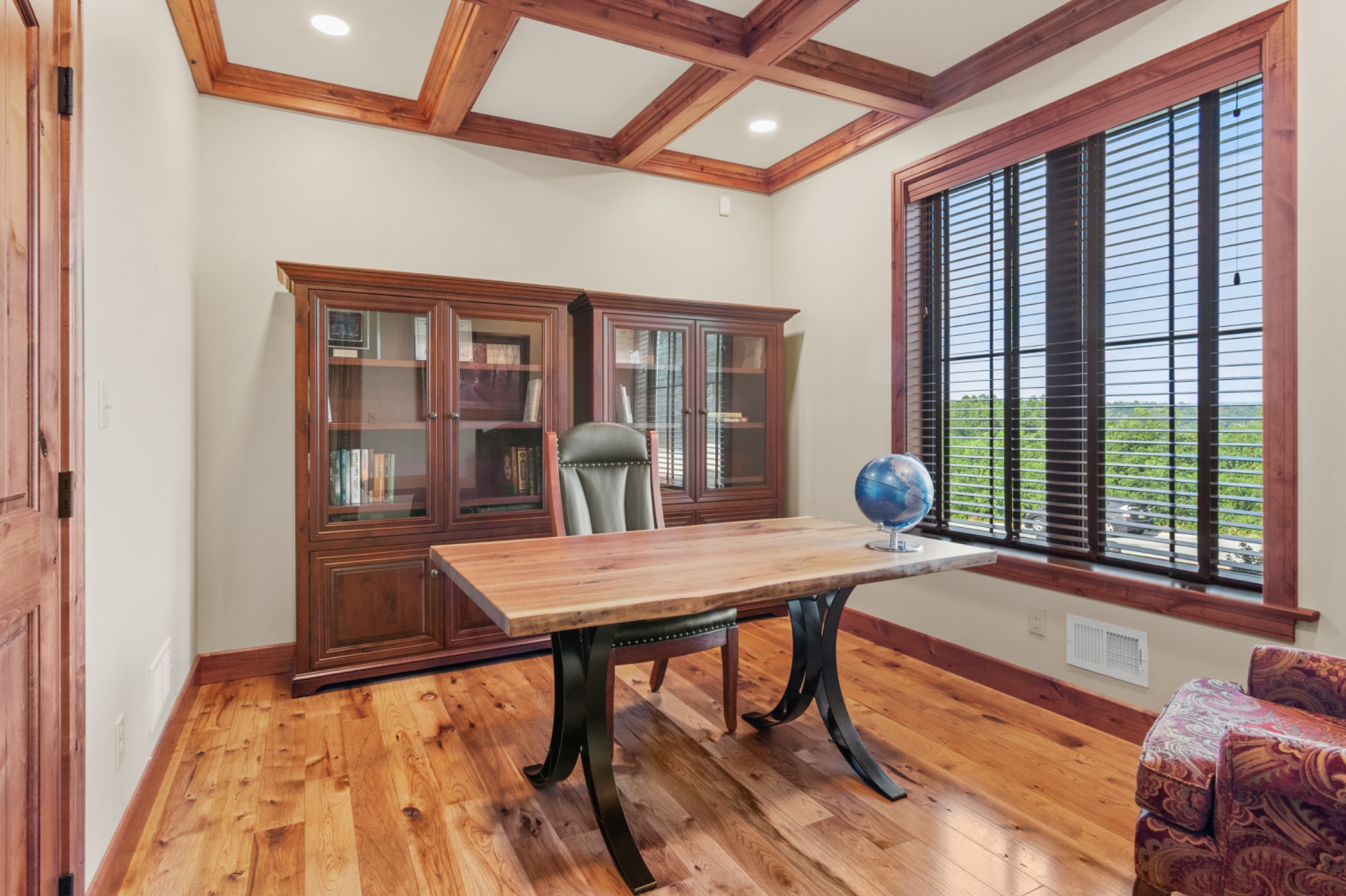 Home office with built-in cabinetry and a window