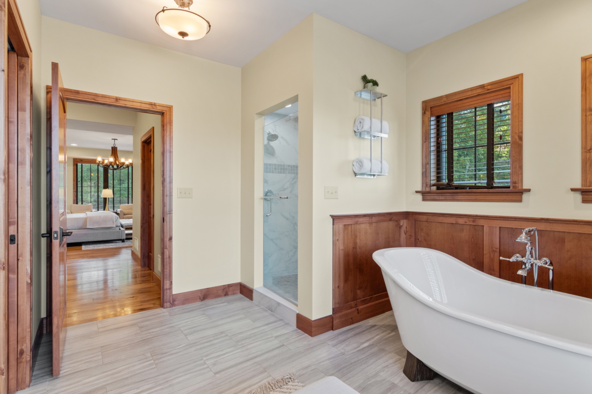 Bathroom with freestanding soaking tub and wood trim