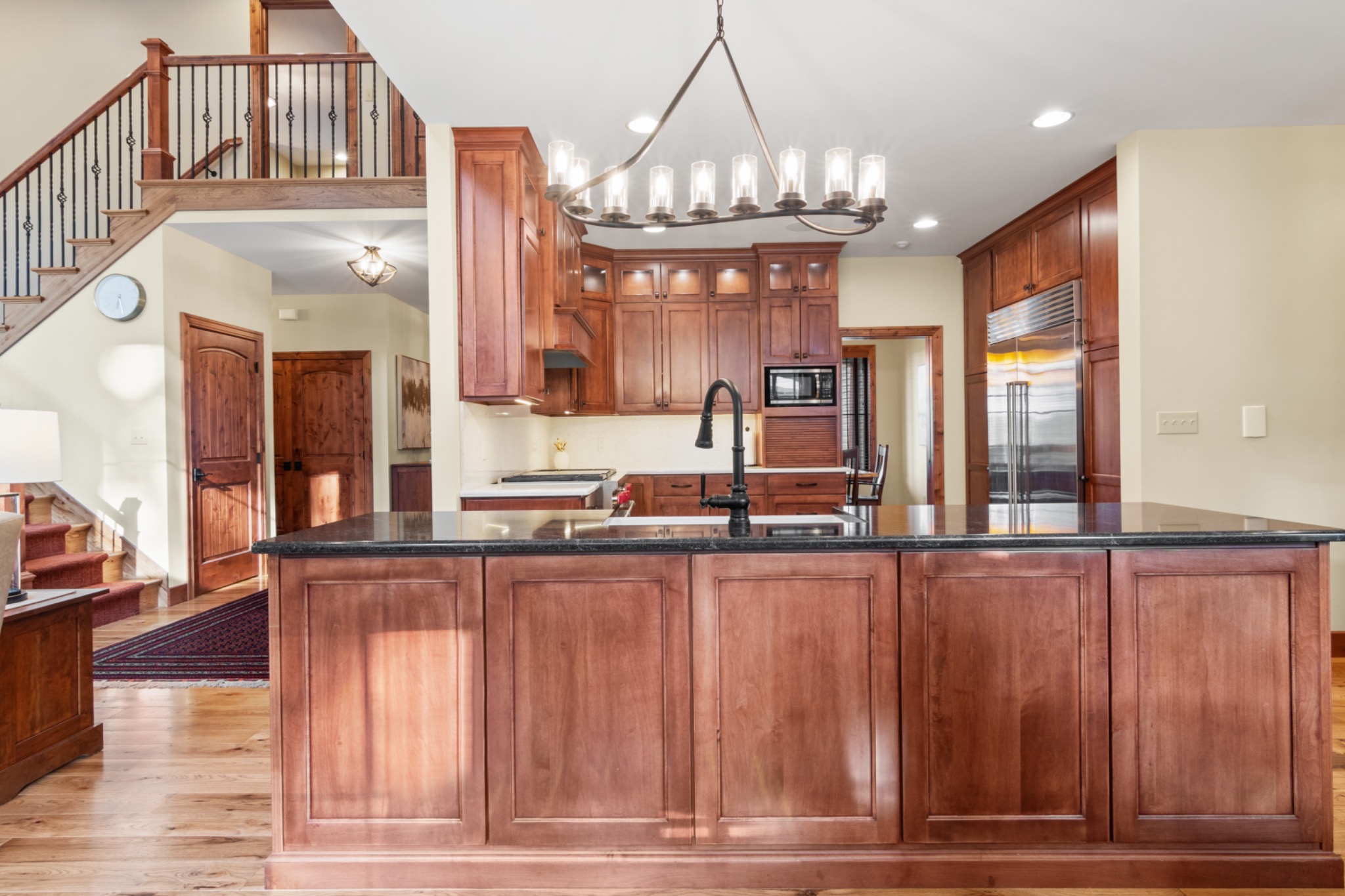 Kitchen with wood cabinets, large island and stainless refrigerator