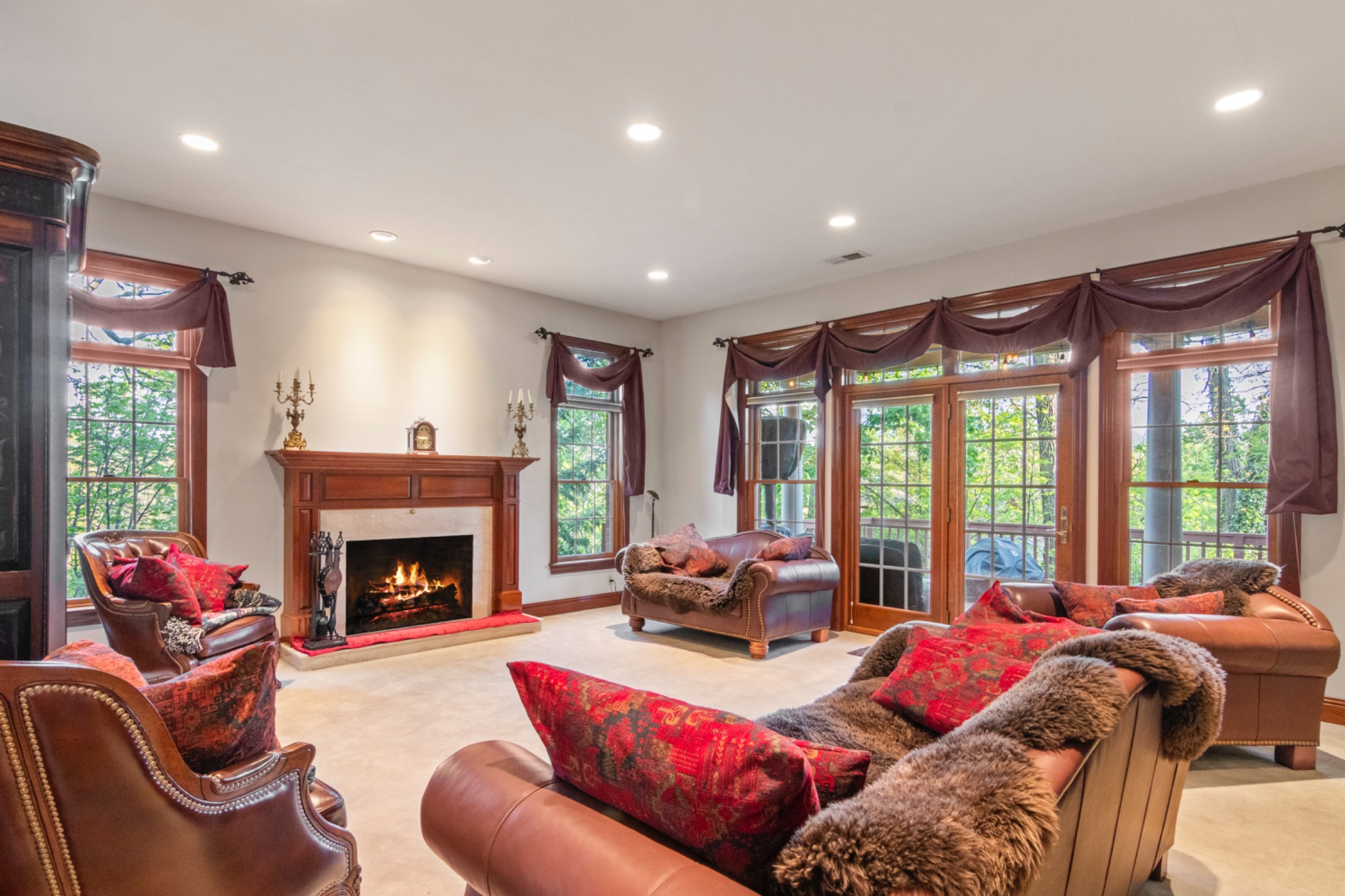 Spacious sitting room with a fireplace and large windows